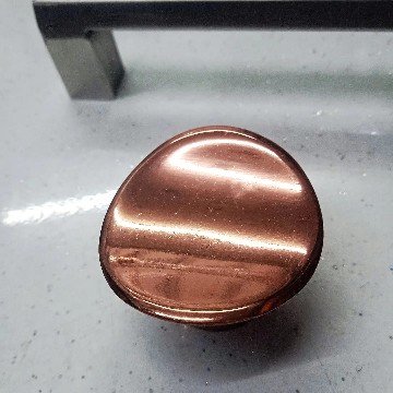 Image (14) Round metallic cabinet knob with a polished copper finish, designed for modern and vintage-style furniture.