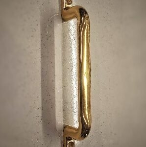Classic gold-finished tubular pull handle with rounded ends and two mounting plates, designed for a timeless and elegant look.
