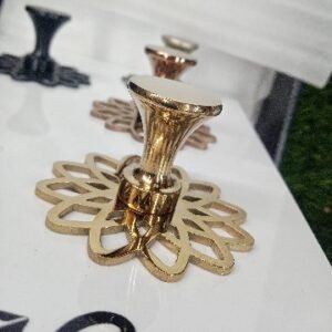 Decorative gold-finished cabinet knob with a flared top and intricate floral-patterned base plate, designed for luxury furniture.