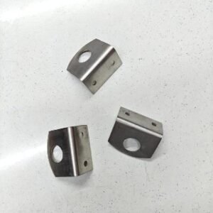 small stainless steel corner brackets with a large central hole and two smaller screw holes for mounting, placed on a white speckled surface