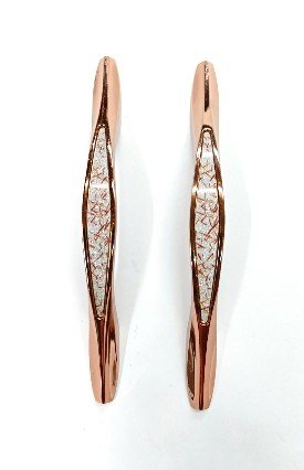 Image (42) Pair of rose-gold finish door pull handles with a decorative textured center in white and gold accents, displayed on a white background.