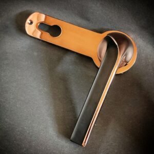 Stylish rose gold and black lever door handle with keyhole plate, modern design for interior doors.
