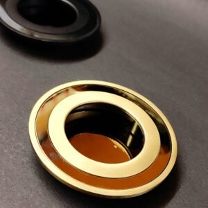 round recessed cabinet pull handles in black, silver, bronze, and gold finishes, placed on a dark background.