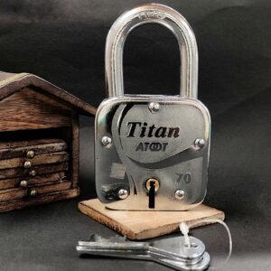 Silver heavy-duty padlock with engraved design, shown with two matching keys on a wooden dark background.