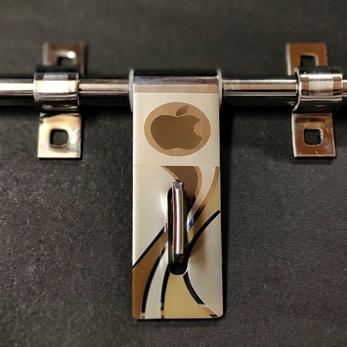 Stainless steel T-bar latch with an elongated slot and decorative laser-etched Apple logo along with abstract wave patterns, displayed on a white background.