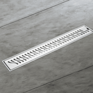 Stainless steel linear shower drain channel with slotted cover, designed for modern bathrooms to ensure efficient water drainage and a seamless floor finish.