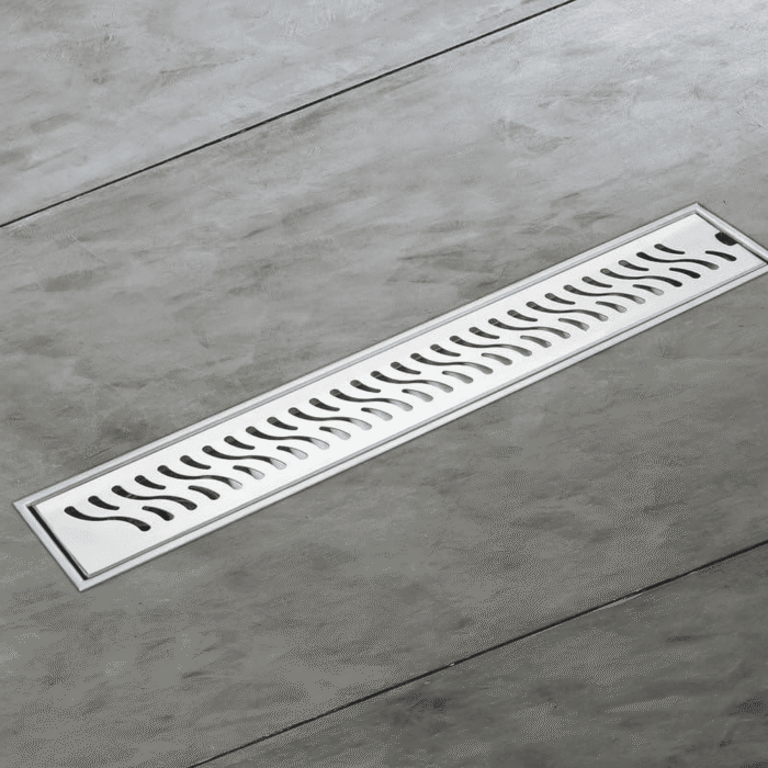 Stainless steel linear shower drain channel with slotted cover, designed for modern bathrooms to ensure efficient water drainage and a seamless floor finish.