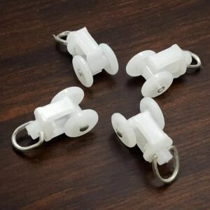 White plastic curtain track rollers with dual wheels and metal hooks for smooth curtain movement on M Track systems.